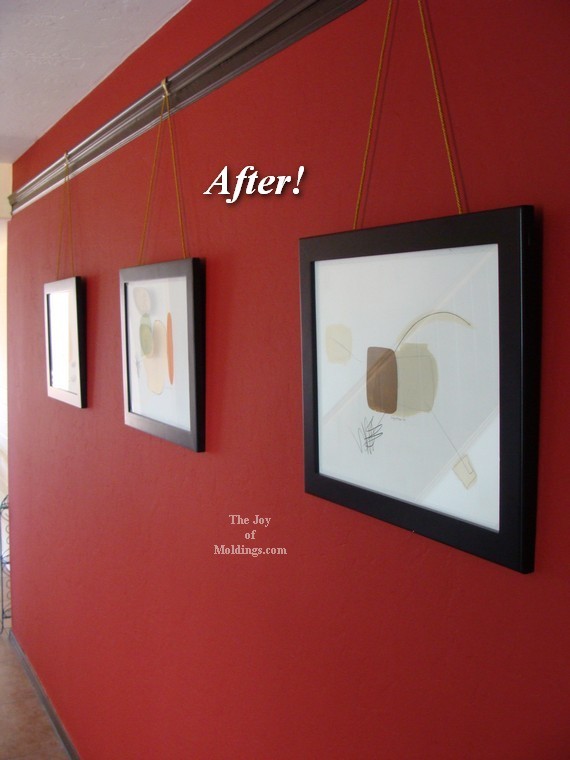 after-picture-rail-molding-red-accent-wall-foyer artwork hanging on picture rail molding
