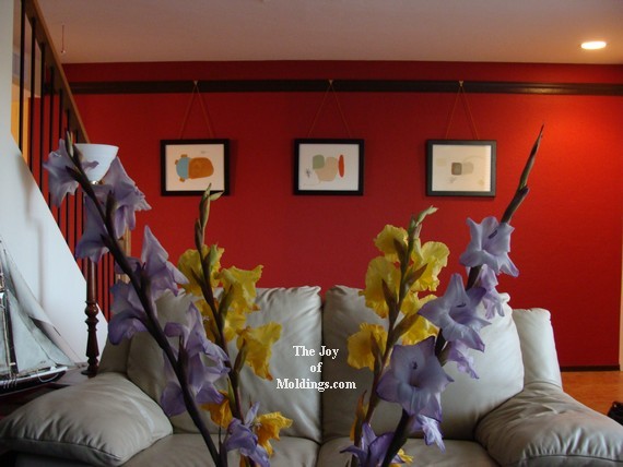 after-picture-rail-molding-red-wall-living-room decorate with picture rail molding